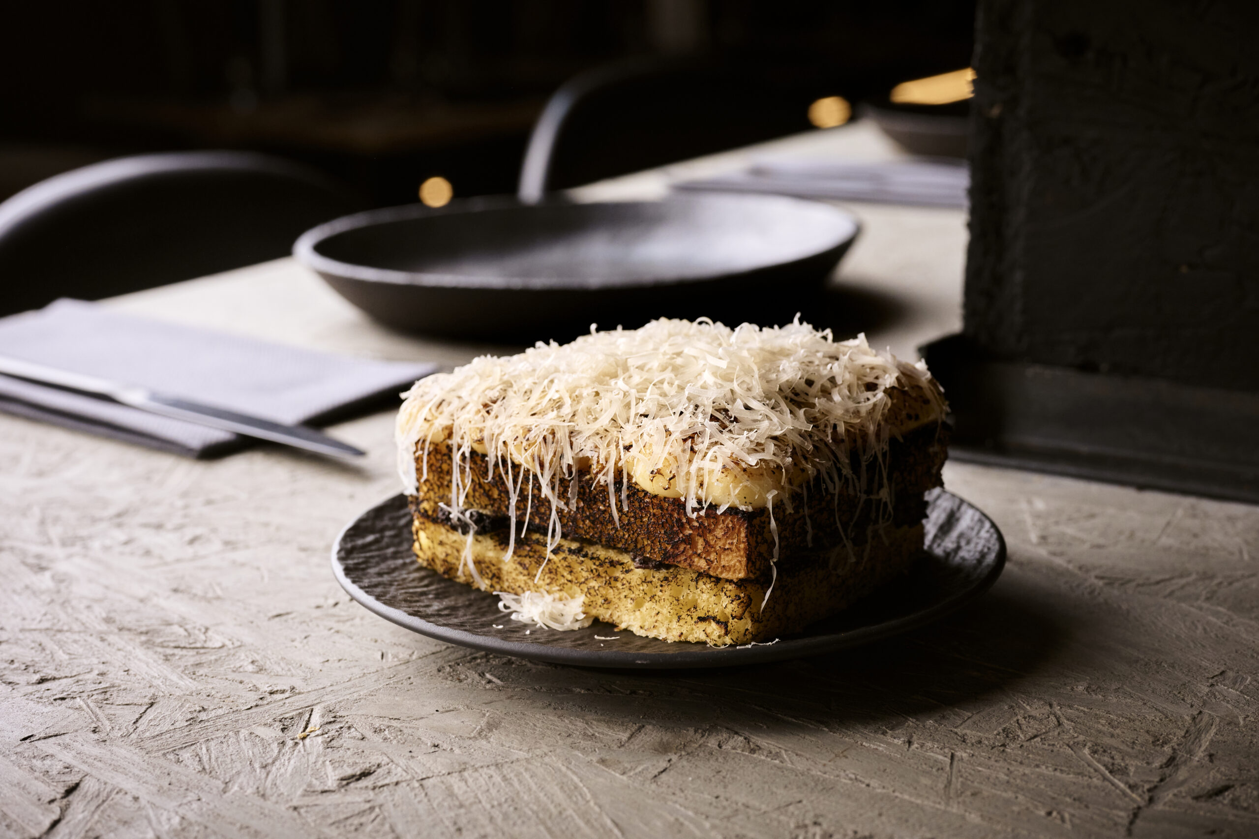 A stack of toast covered in grated cheese
